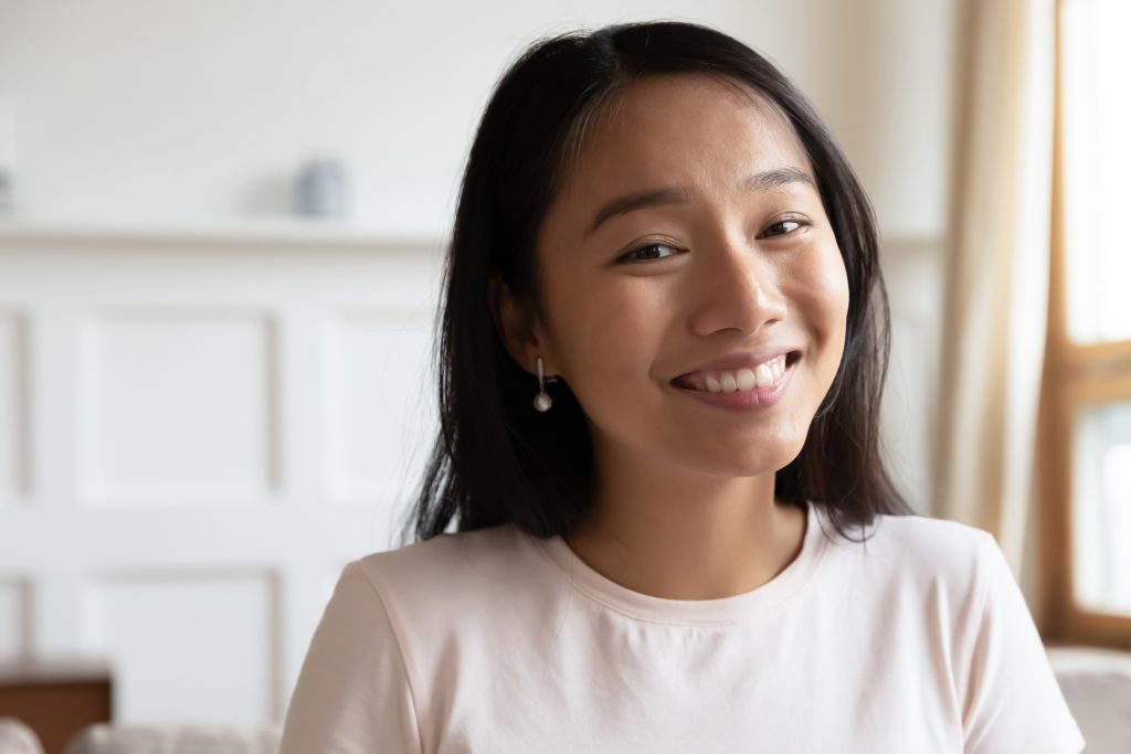 Headshot portrait screen application view of happy millennial Asian girl talk on video call online, smiling young ethnic woman speak have pleasant Webcam chat on laptop, quarantine alone at home